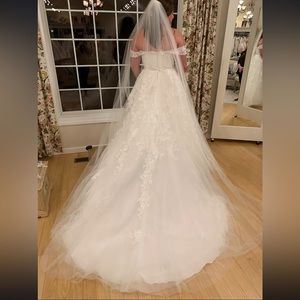 Gorgeous off the shoulder lace wedding gown with a tulle glitter underlay.